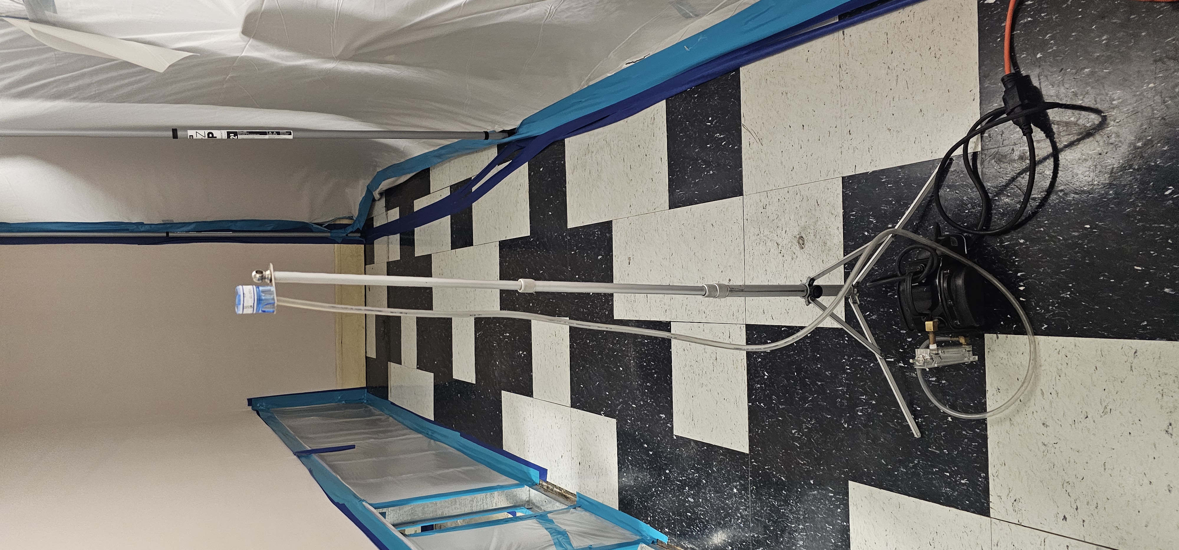 Air movers and drying equipment placed throughout an indoor hallway to help dry affected areas and prevent mold growth.