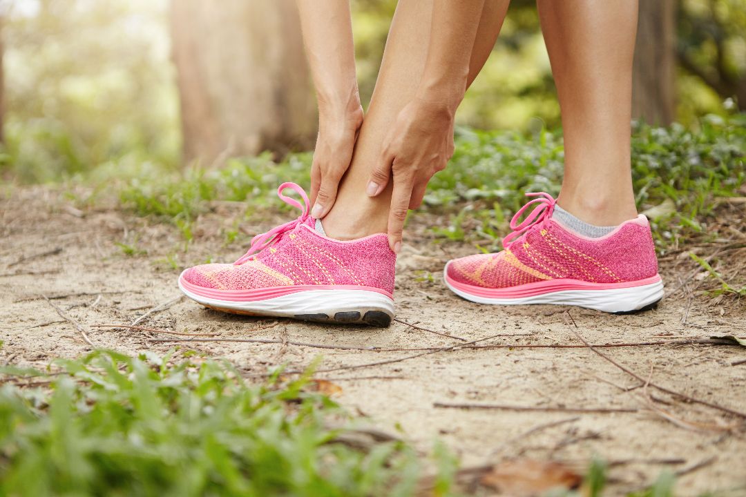 woman-runner-holding-her-ankle-after-running-exercise-outdoors.jpg