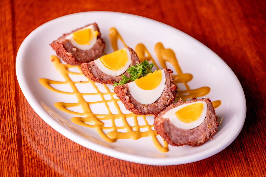 delicately boiled egg wrapped in sausage & parmesan breadcrumbs, served with spicy pub mustard