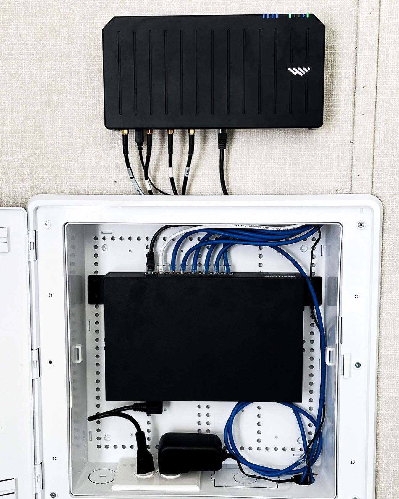 Network equipment enclosure with organized Ethernet cabling and installed networking hardware