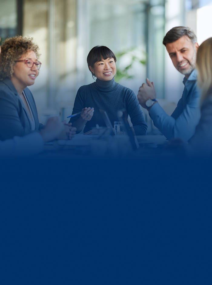A business owner and her colleagues at a boardroom table.