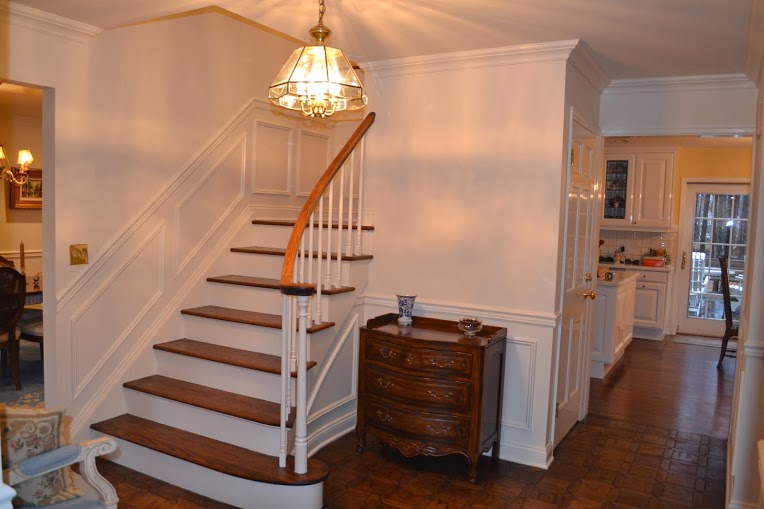 New wainscoting and interior painting provide a warm, welcoming foyer.