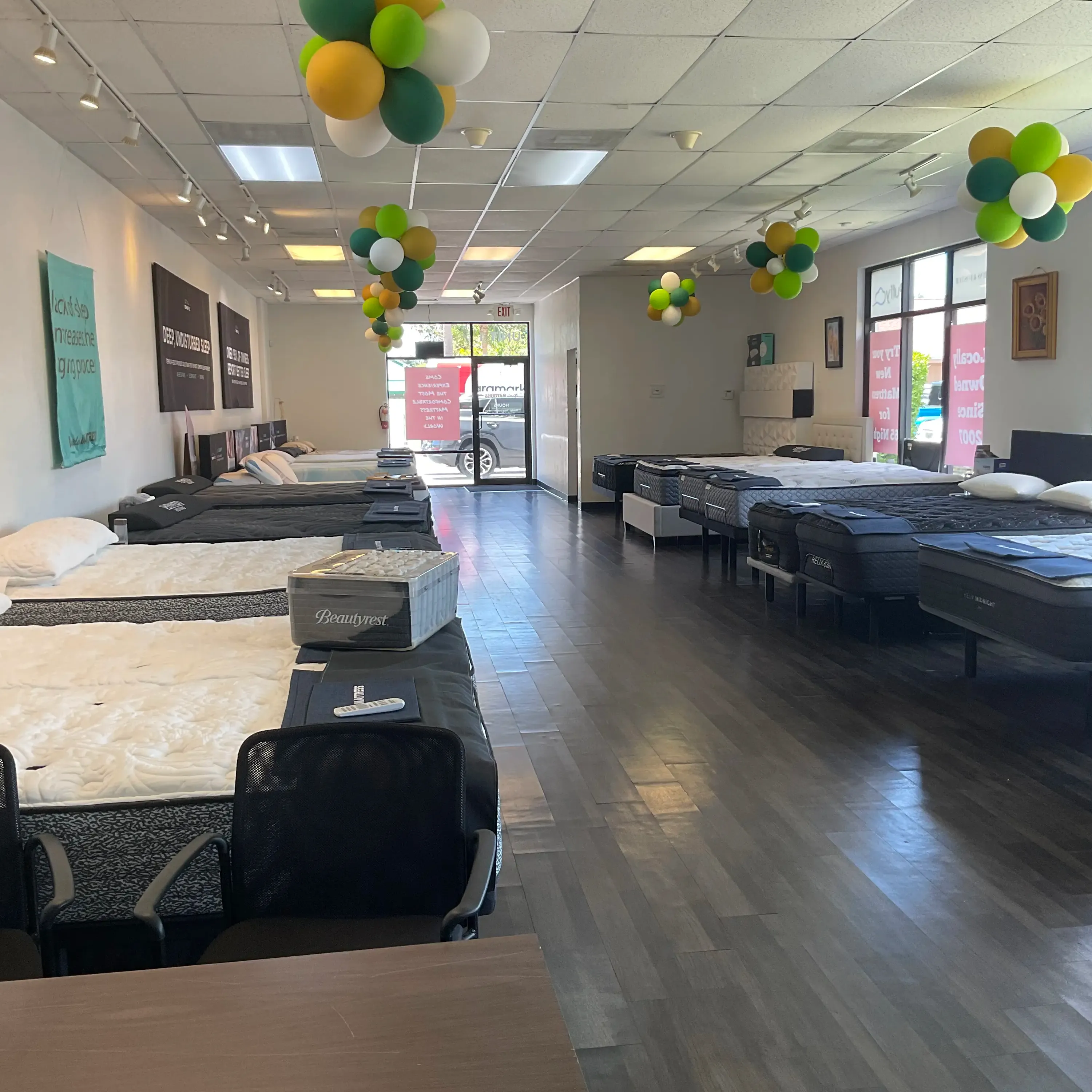 View toward the front entrance, featuring the showroom&rsquo;s mattress selection and colorful decorations.