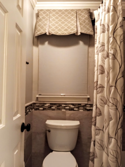 50 shades of grey all in one bathroom! This custom window treatment was designed to pull together the different tones of grey from the tile and stone in this bathroom. We were able to highlight different shades and really pull the space together.