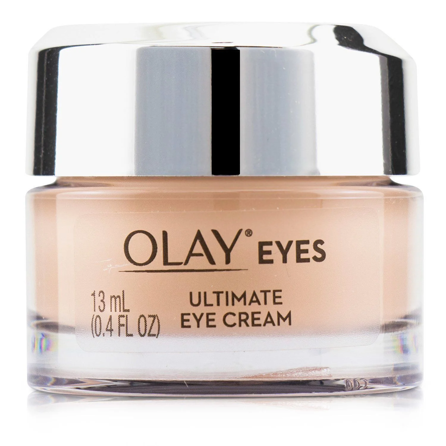 A close-up studio shot of a jar of Olay Eyes Ultimate Eye Cream against a white background. The jar has a clear glass base and a silver metallic lid. The label on the front of the jar is light beige and displays the Olay Eyes logo, the volume of 13 ml (0.4 FL OZ), and the text "ULTIMATE EYE CREAM".