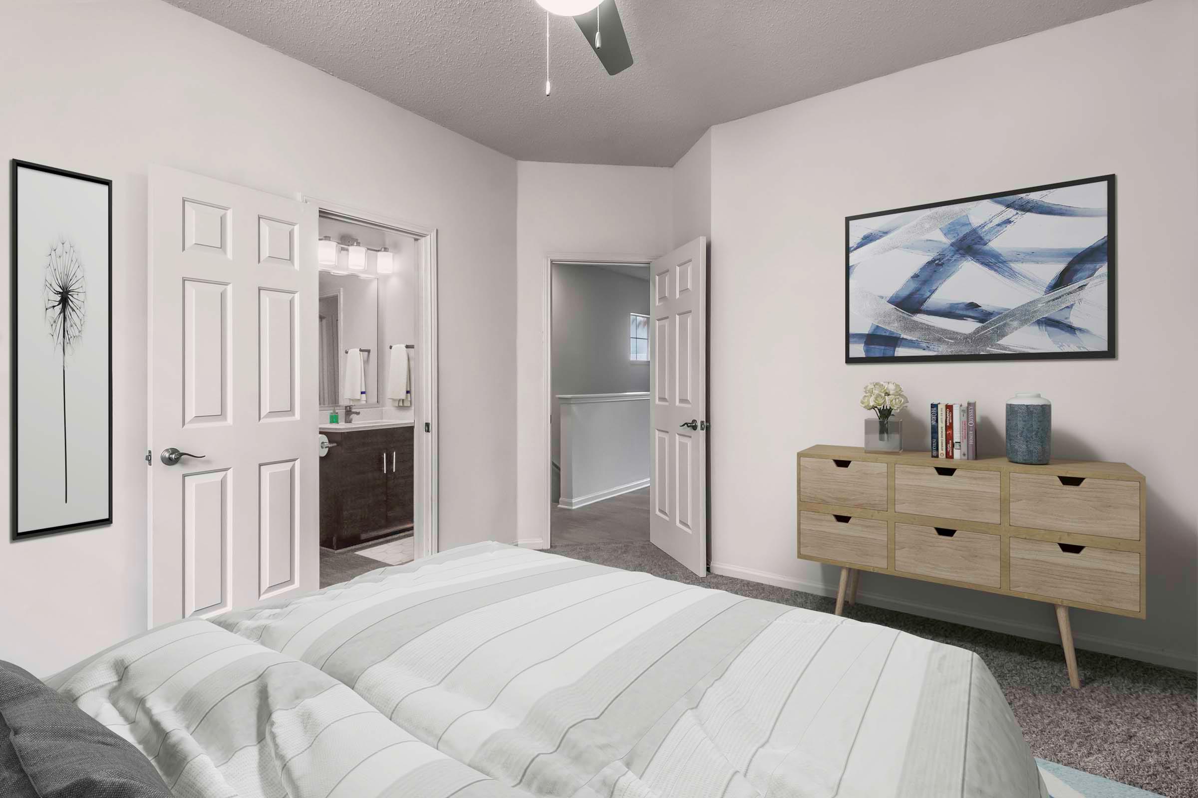 Townhome bedroom with ensuite bathroom carpet flooring and ceiling fan Camden Deerfield Apartments Alpharetta (770)872-6592