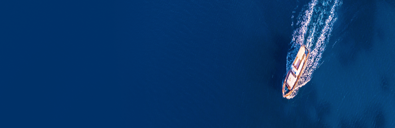 A top-down view of a yacht in open water.