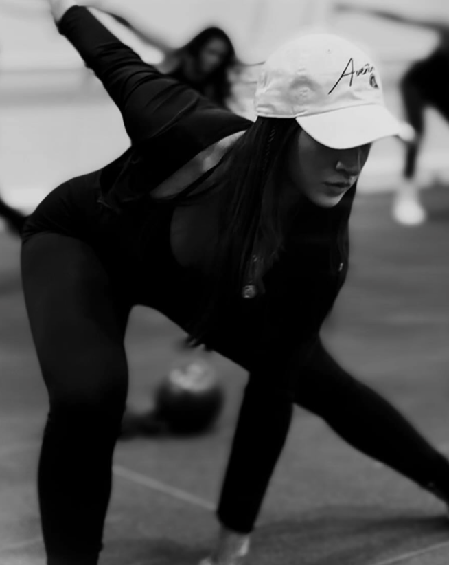Pure Barre Aventura member performing a dynamic lunge during a barre fitness class in Aventura, FL