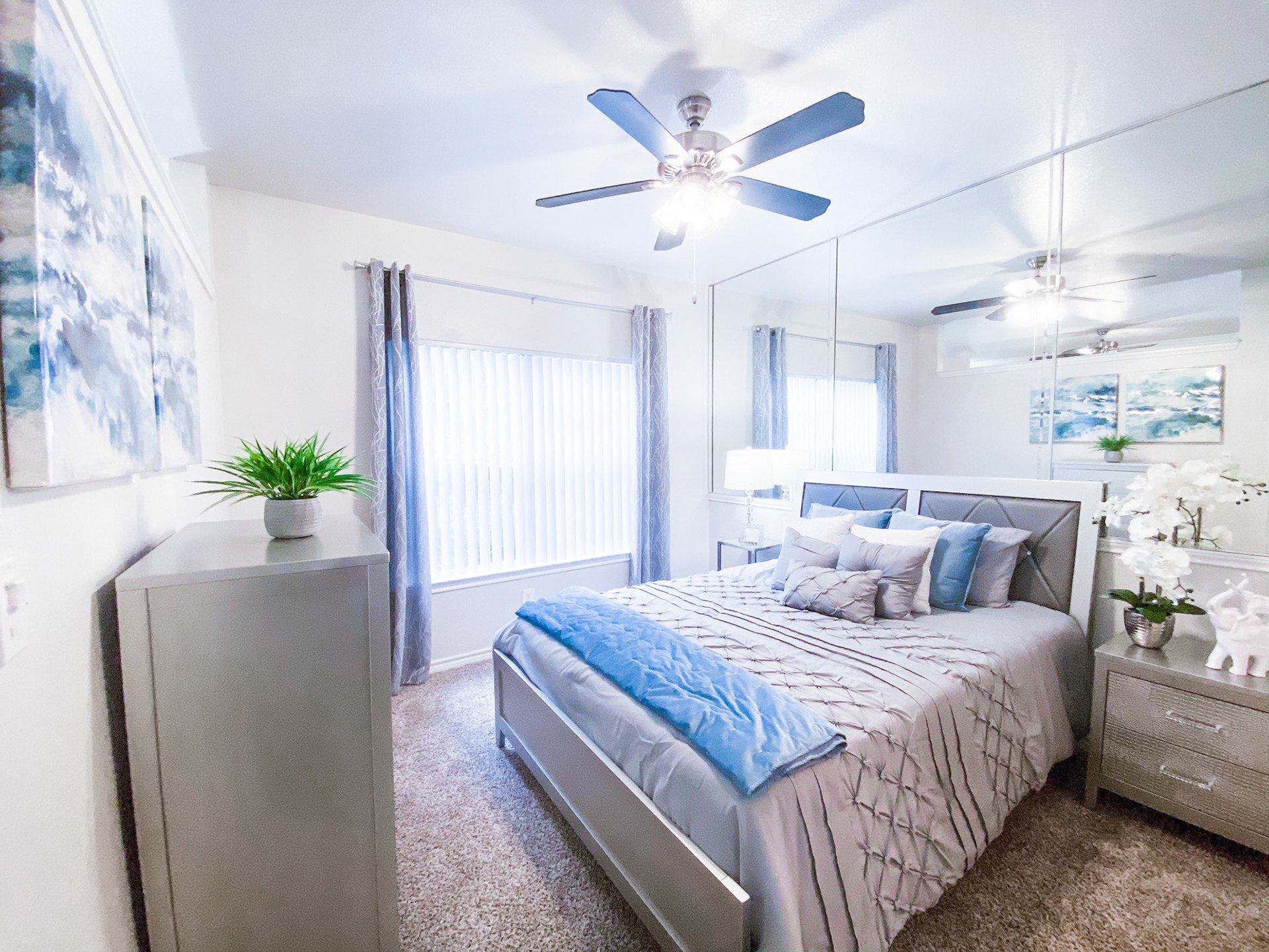 Well-lit bedroom with ceiling fan