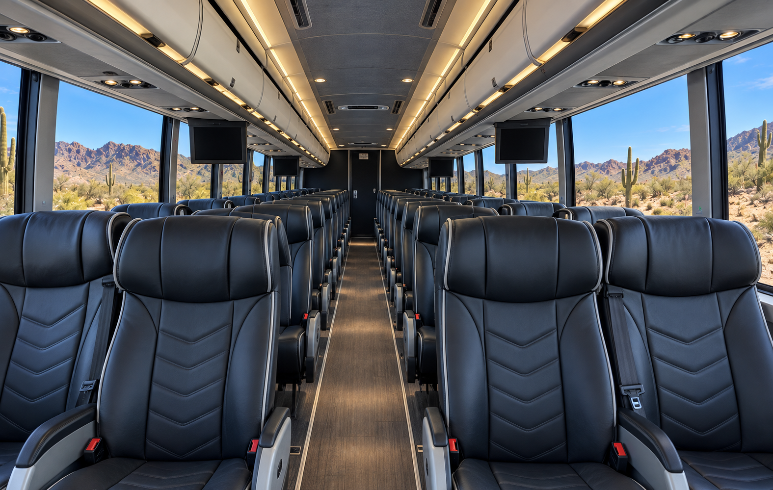 Coach interior with high-back black leather seating and overhead storage.