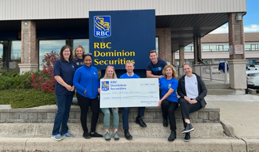 Members of the Madison Group with a giant cheque supporting RBC Race for the Kids.