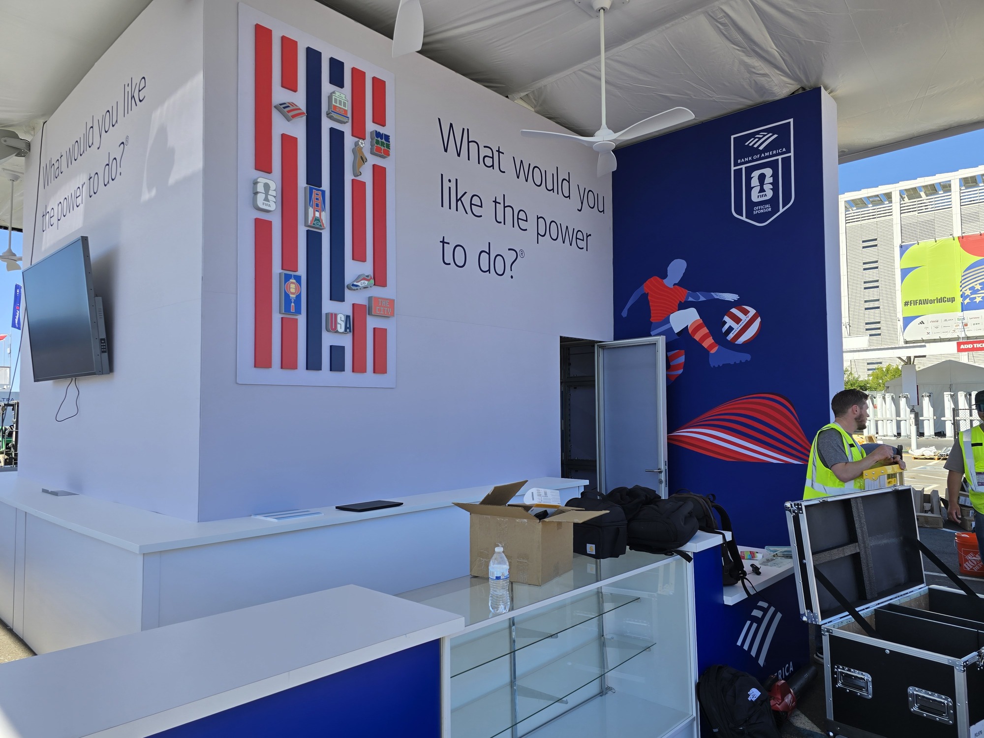 Interior view of the Bank of America event pavilion featuring custom counters, FIFA World Cup graphics, branded wall displays, and integrated digital screens.