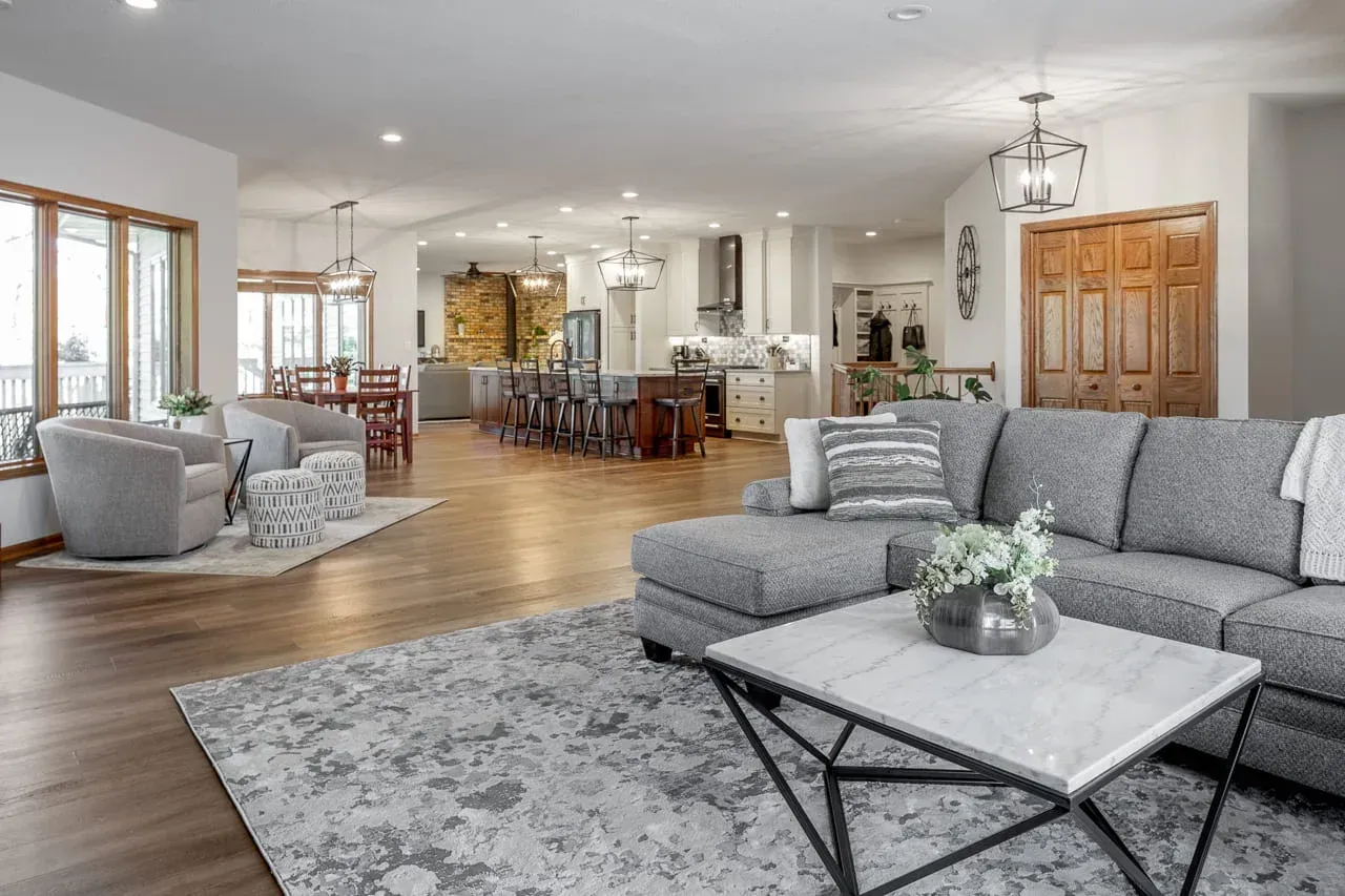 Bright and spacious open-concept living area featuring hardwood flooring, updated lighting, and remodeled kitchen. Designed to improve comfort, functionality, and visual appeal throughout the home.