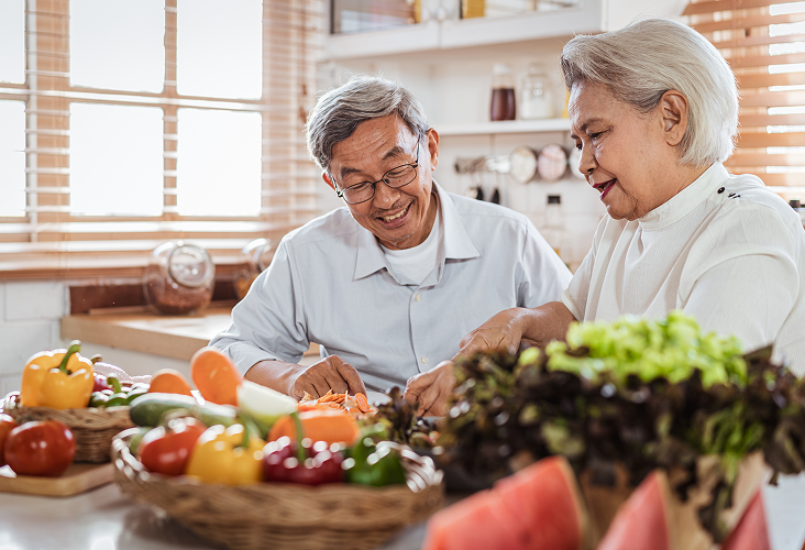 A married couple sharing a moment together in the kitchen.