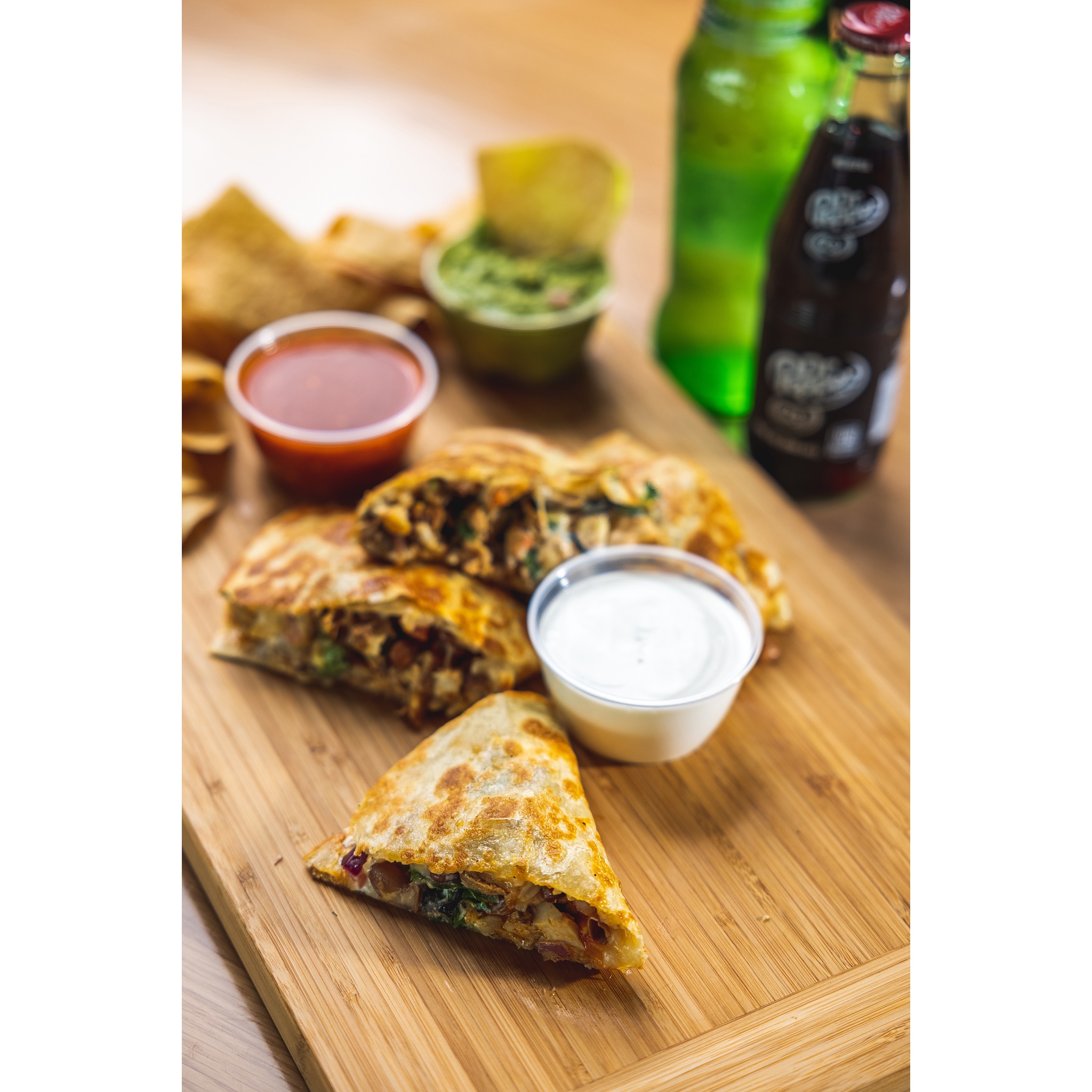 Stuffed quesadilla with salsa and queso and Classic mexican coke 