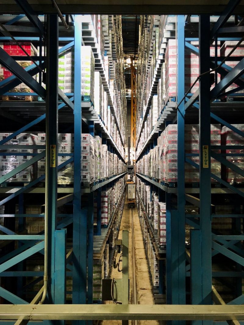Detailed interior view of a San Francisco fulfillment center's packaging area, where employees meticulously prepare orders for shipping, with rows of packed boxes ready to be dispatched."