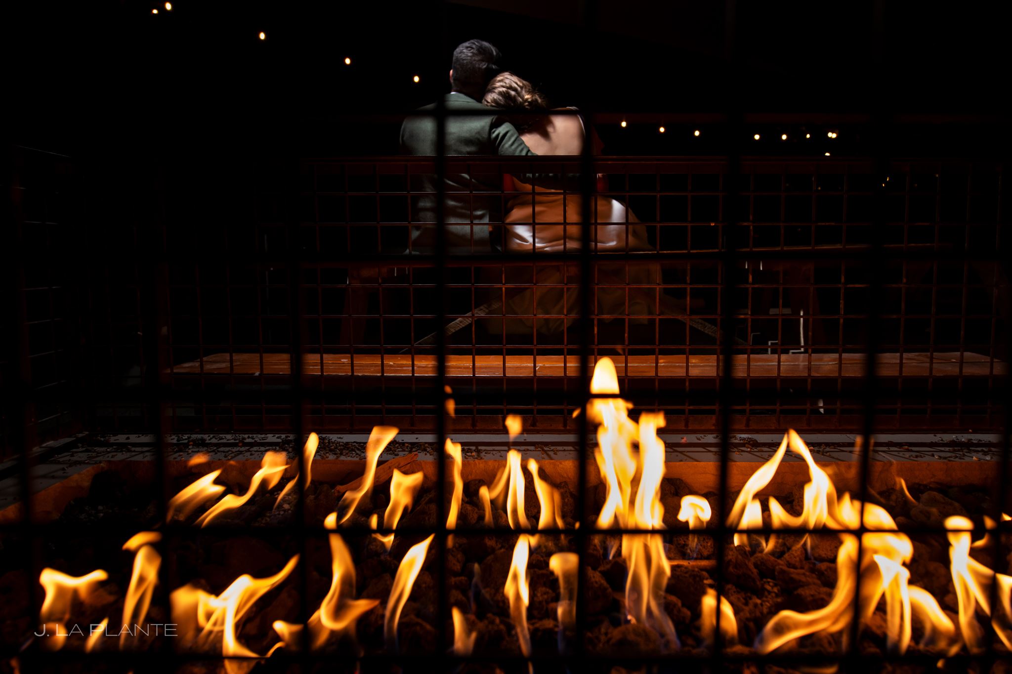 A warm fire feature creates a cozy atmosphere for guests enjoying cider, cocktails, and mountain views at Acreage.