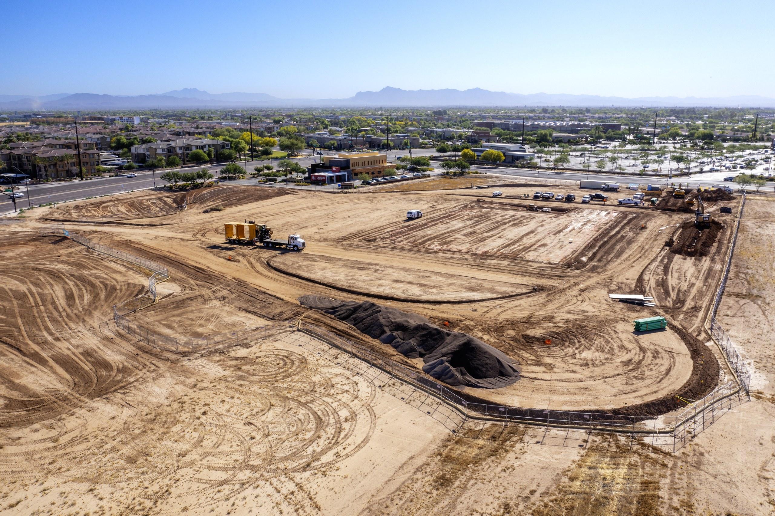 Construction aerial of the ALDI site in Gilbert, Arizona, with the East Valley and mountains behind  