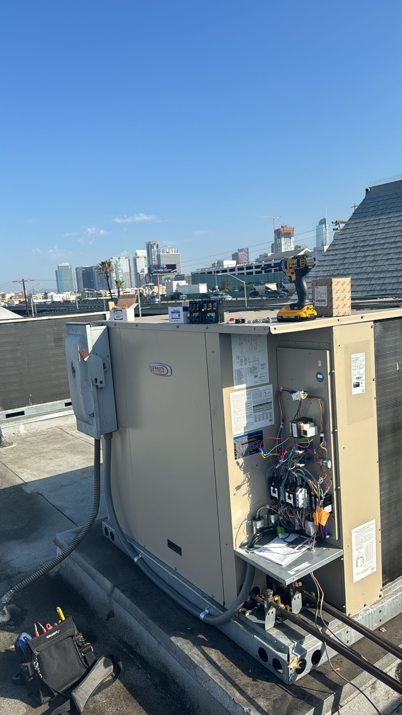 Three large commercial pressure fryers arranged beneath a stainless steel ventilation hood, featurin 