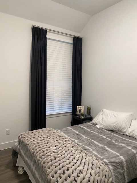 Black curtains with white faux wood blinds is chic and classic. Budget Blinds of Rockwall, Terrell, Forney, and Greenville love making our client's dream homes a reality.