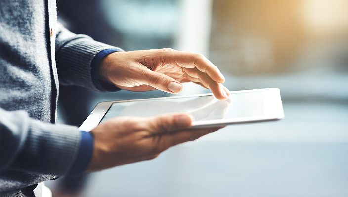Close-up of a person using their tablet.