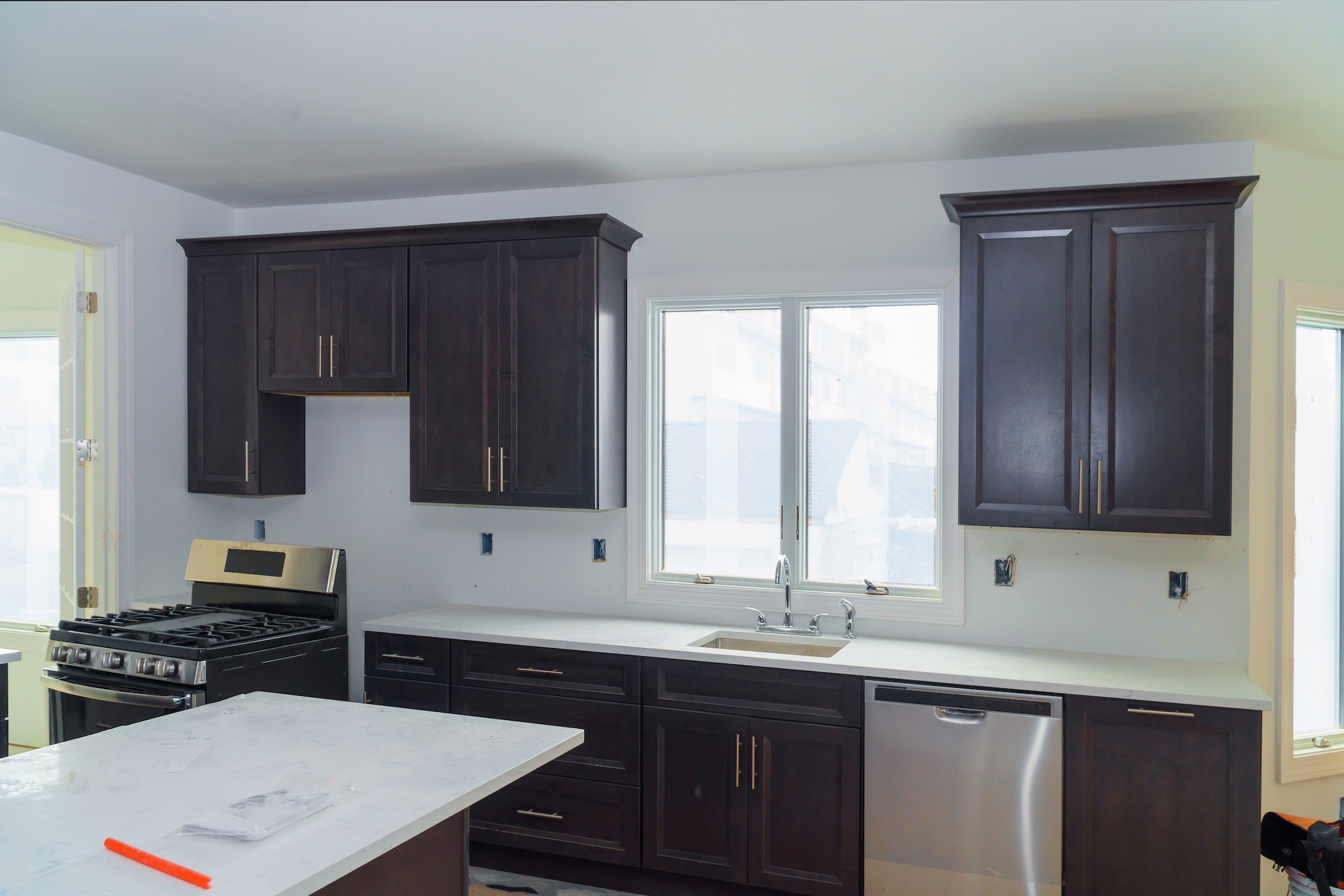 Kitchen with dark cabinets after cabinet painting in Duxbury