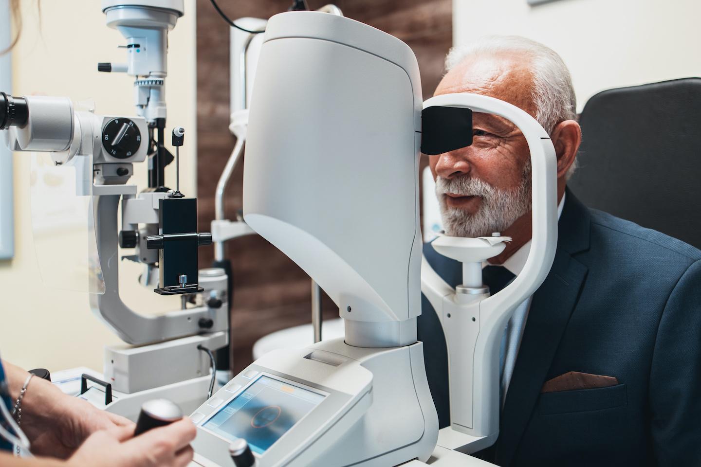 Bearded man receiving an eye exam.
