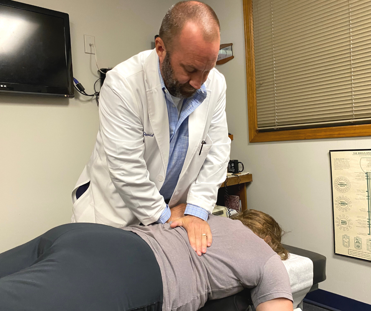 Chiropractor Dr. David Fike adjusts a patient's back at Fike Chiropractic & Acupuncture - Tulsa
