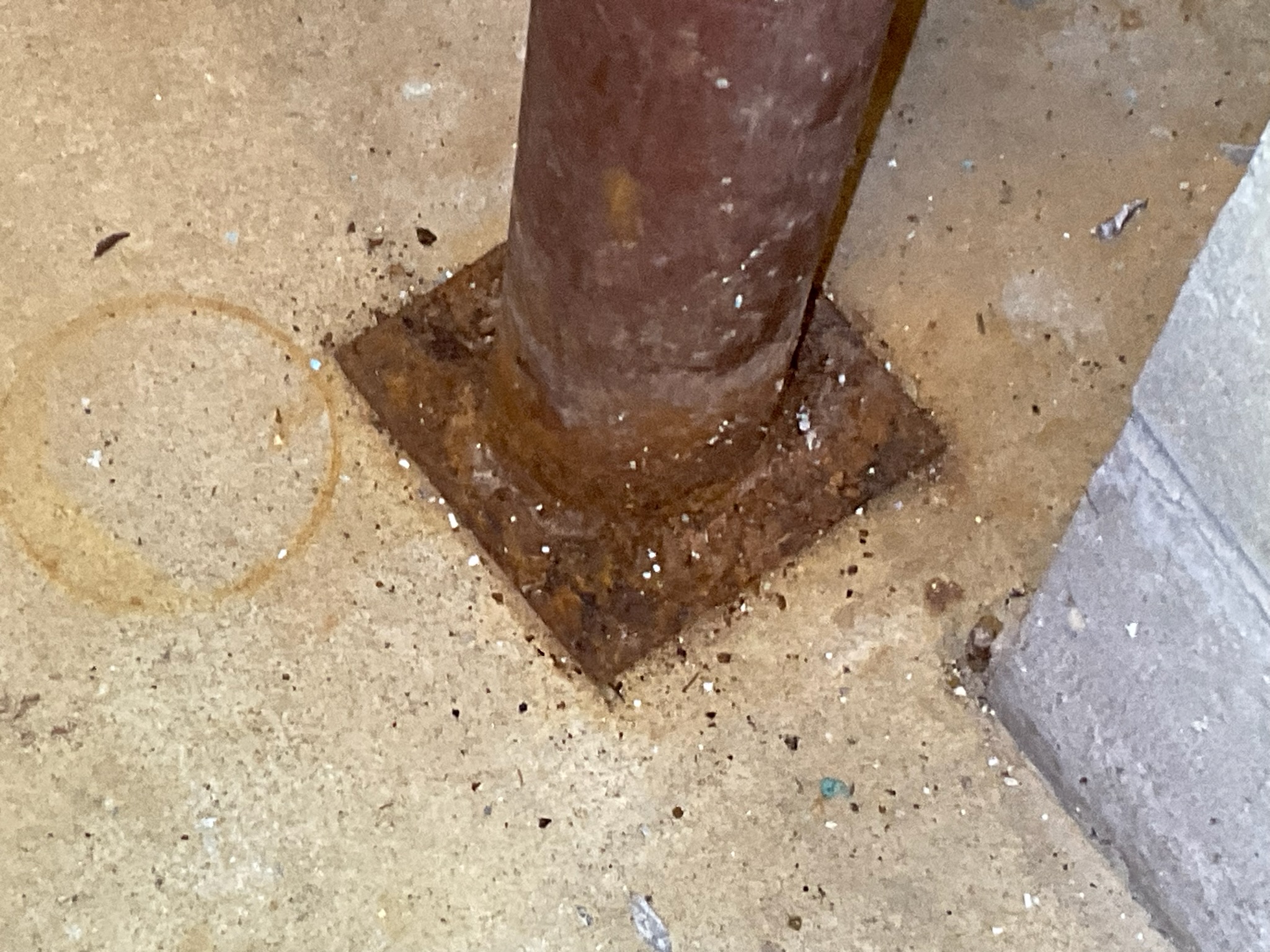 Rusty support columns are a sign of past water intrusion and can damage structural integrity.