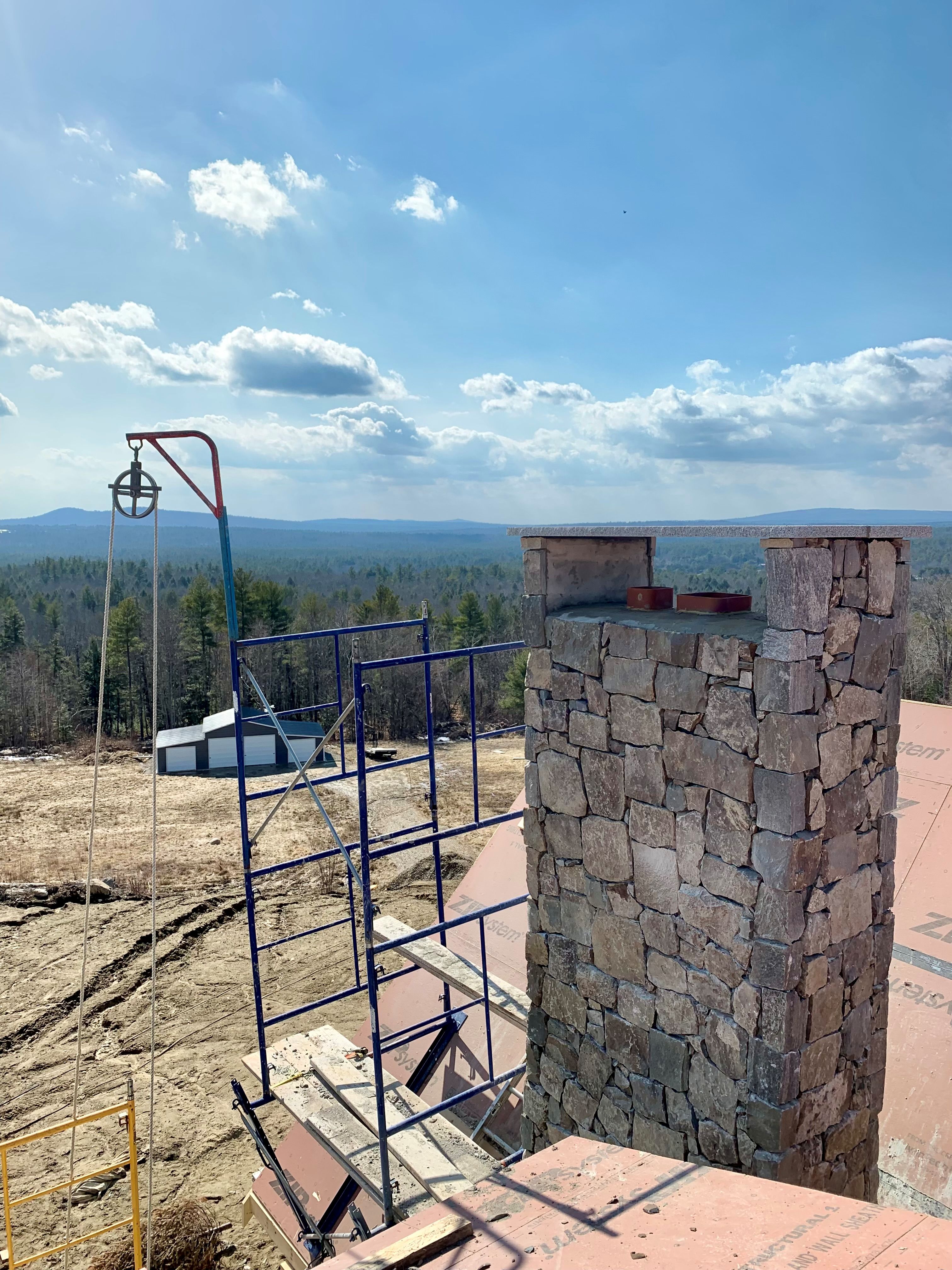 Custom stone chimney constructed by Mac's Masonry using natural stone veneer and expert masonry techniques. Designed for durability, weather resistance, and a timeless appearance that complements the home's architecture.