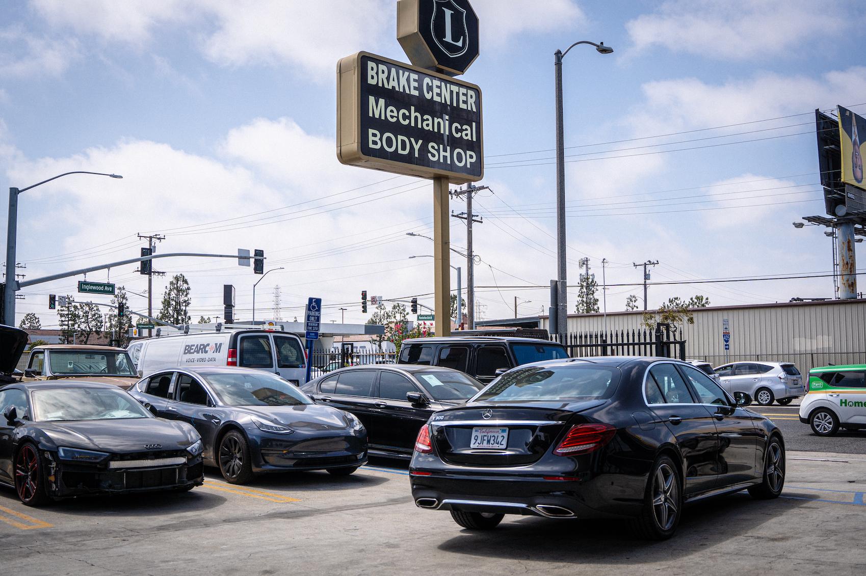 Detailed photo of Mercedes waiting at auto body shop parking lot for collision repair