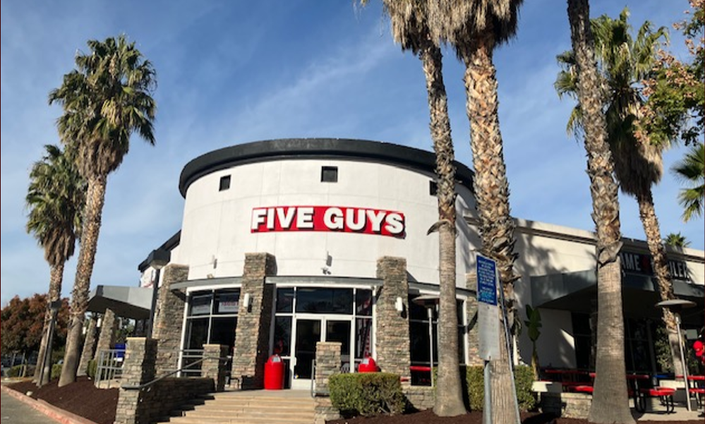 Exterior photograph of the Five Guys Restaurant at 929 N. Milliken Avenue in Ontario, California. Five Guys Ontario (909)284-9169