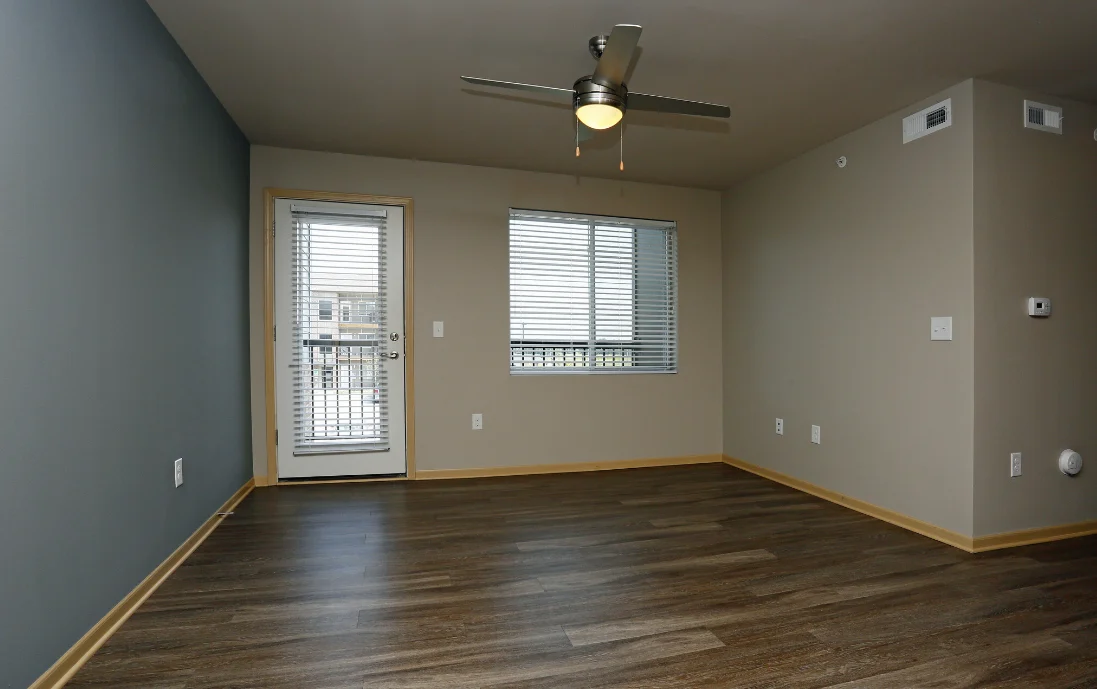 Room with balcony access and ceiling fan