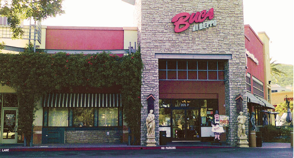 Buca di Beppo Thousand Oaks exterior showing two statues by the front door and a big Buca sign on brick.