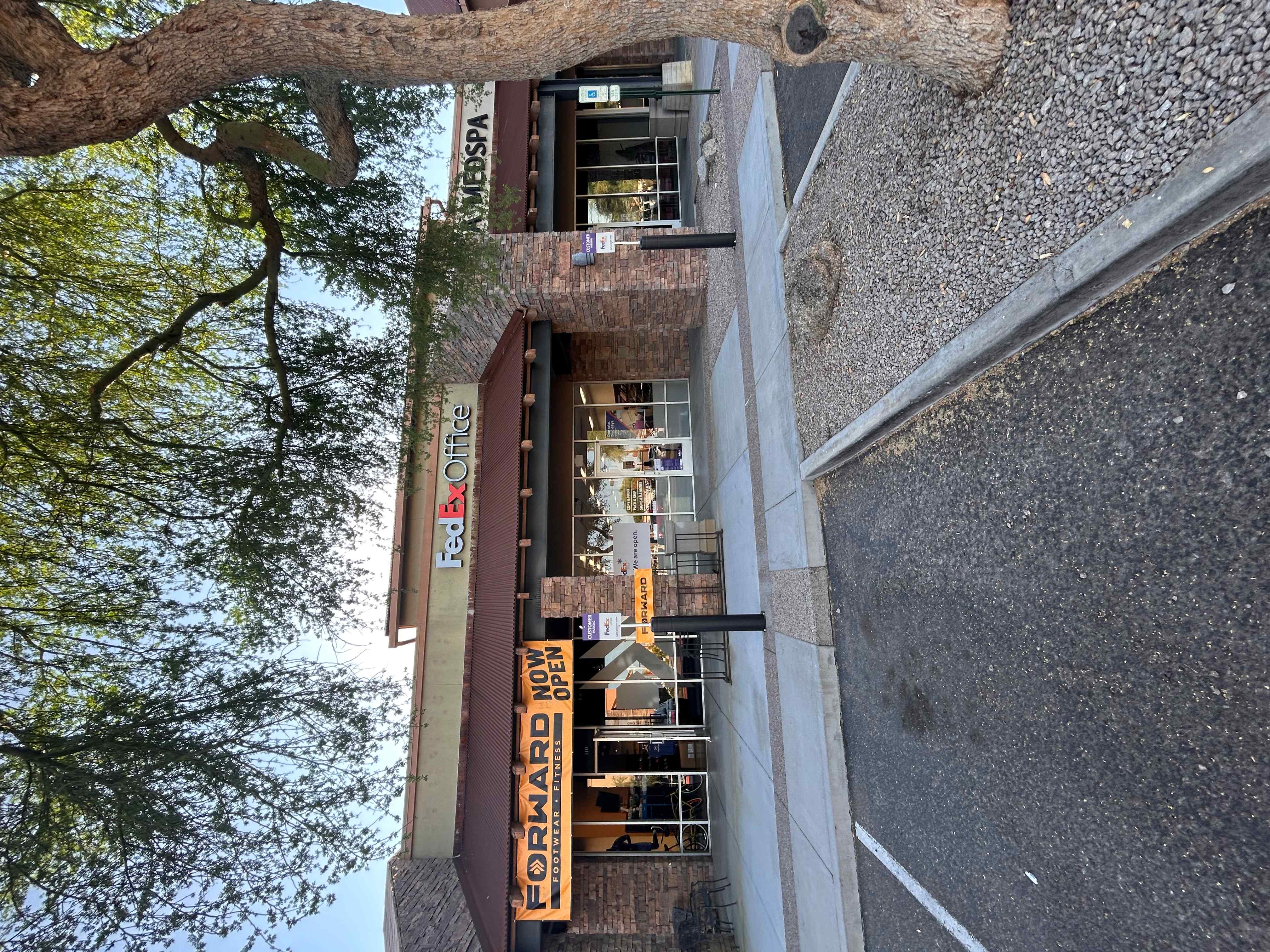 View of the FedEx Office in its shopping center on N Power Rd in Mesa, AZ, with a large 