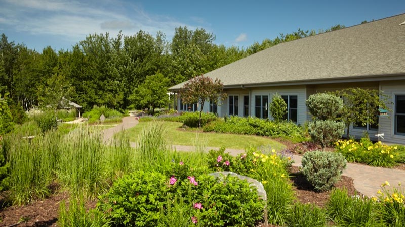 exterior view showing the south garden and building of Aspirus Hospice House