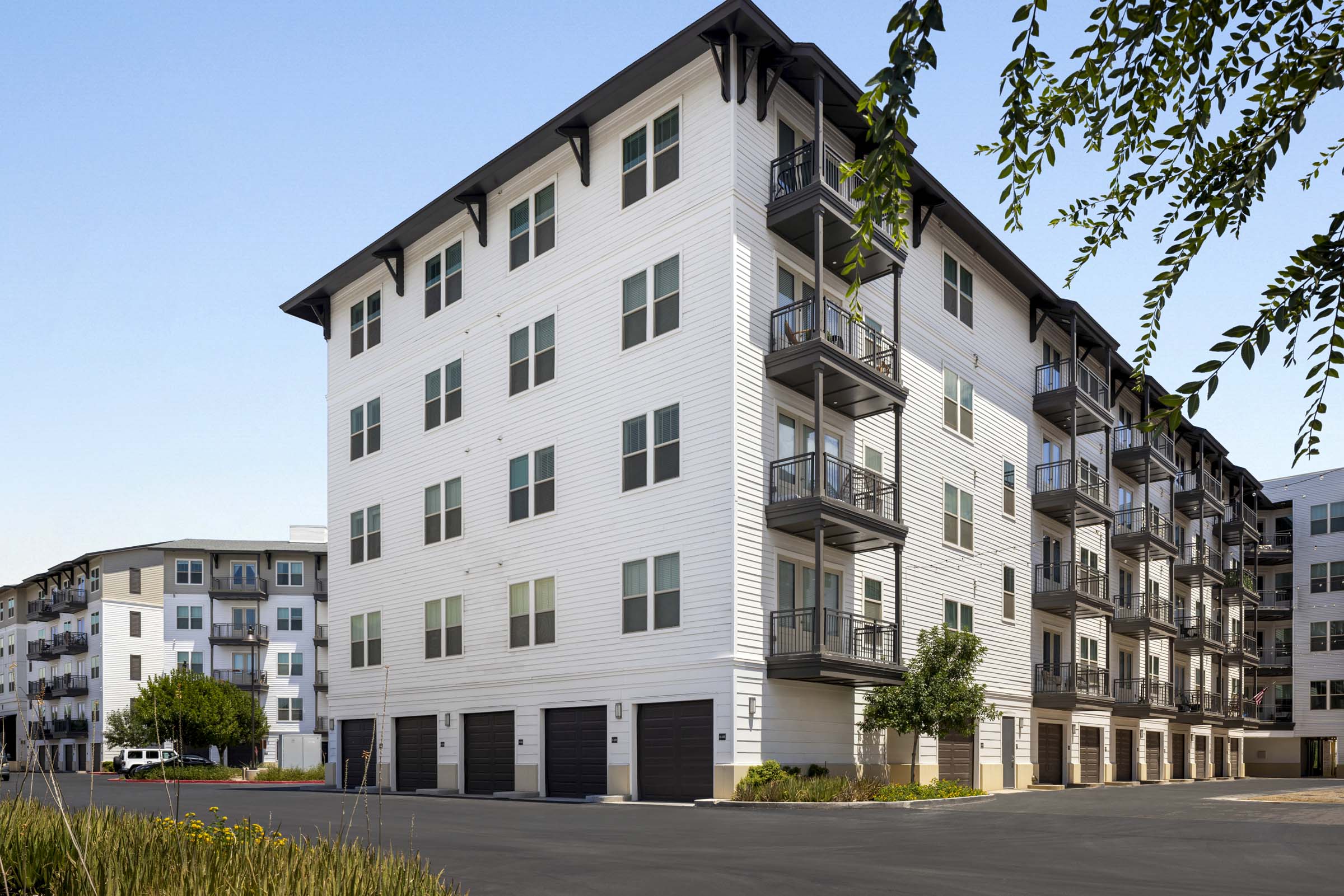Building exterior with private garages and balconies at Camden Gilbert apartments in Gilbert, AZ 
