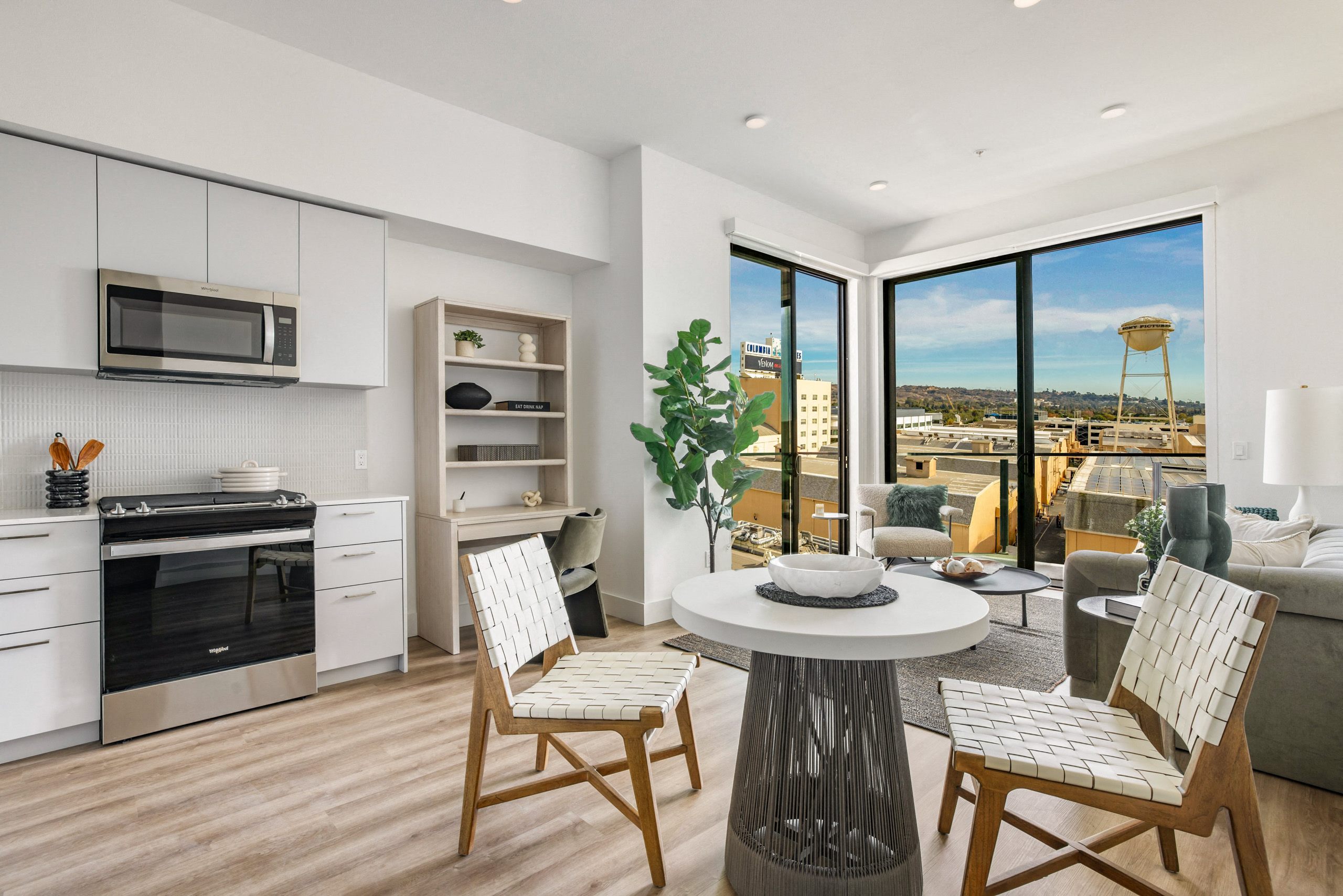 A modern kitchen with a dining table and chairs.