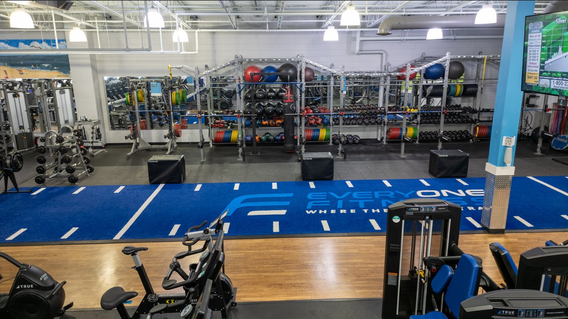 Performance turf training area at Everyone Fitness Rehoboth Beach with sled lanes, racks, and functional gear.