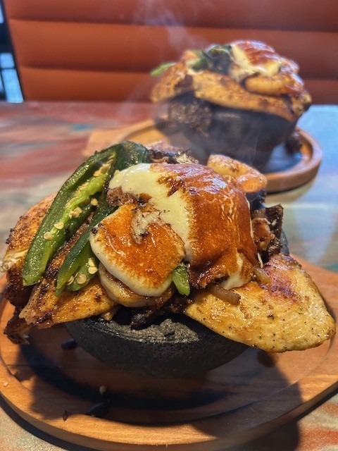Molcajete for Two served at Catramex Restaurant featuring a sizzling combination of grilled meats, seafood, vegetables, and authentic Mexican flavors perfect for sharing in Southern Maine.