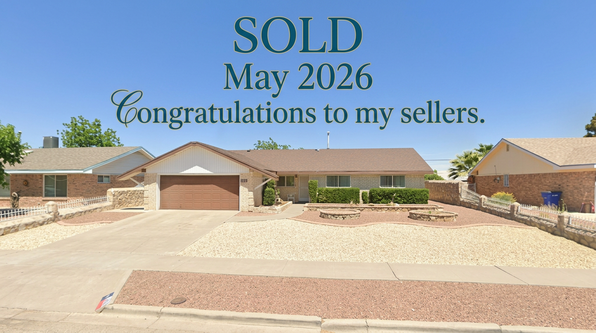 A single-story house with a beige brick exterior is shown under a clear blue sky. The house has a brown garage door and a white-trimmed entryway. The front yard is landscaped with gravel, low bushes, and a decorative stone fire pit. Text overlays the image, reading "SOLD May 2026 Congratulations to my sellers." Another house is visible to the left, and part of another house is visible to the right. The overall scene suggests a residential property that has recently been sold.