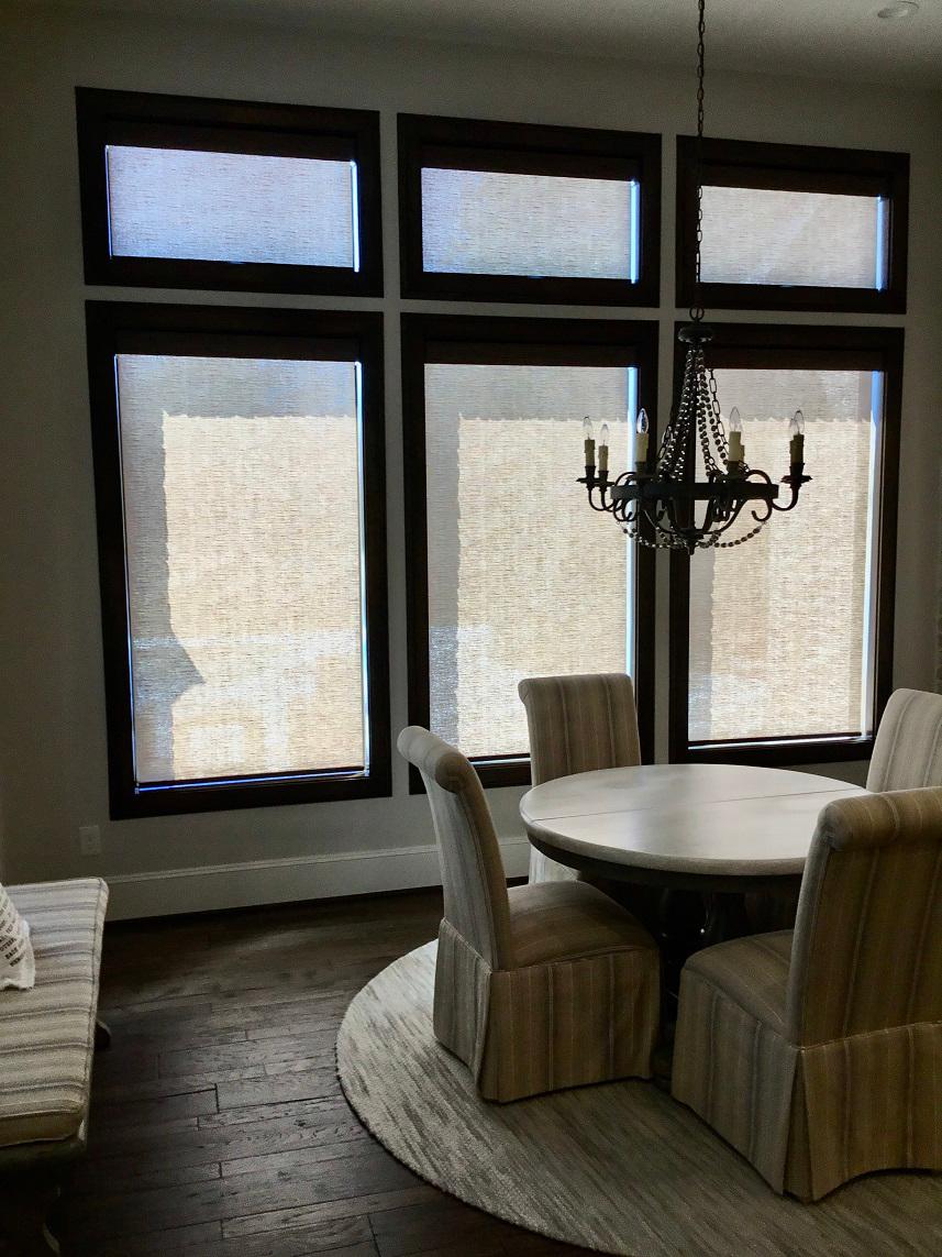 Hunter Douglas Motorized Shades by Budget Blinds of Katy & Sugar Land give this Sugar Land, TX dining area state of the art design and style while providing privacy and light control.