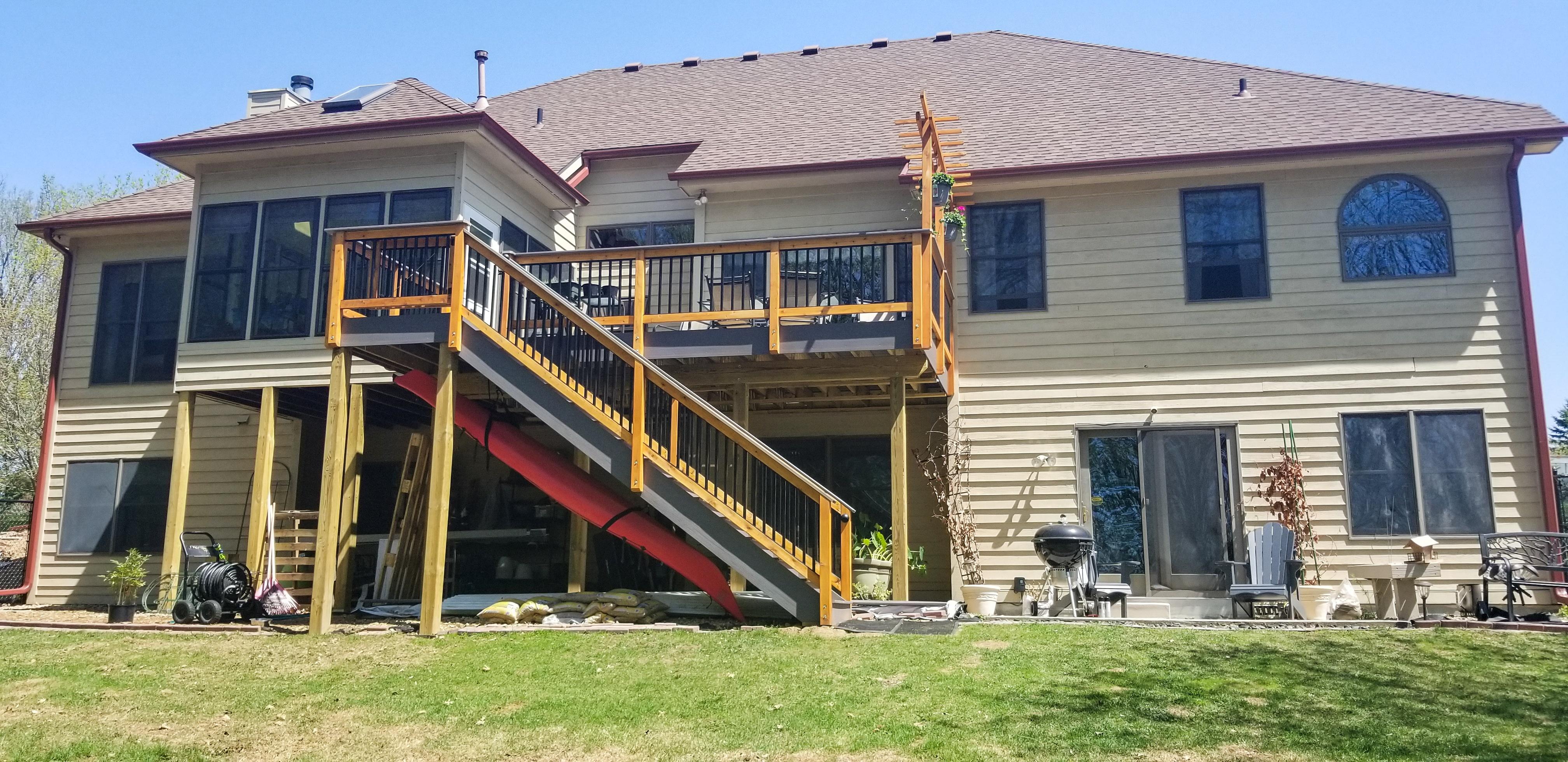 Custom color seamless gutters and downspouts installed on a large two-story home by Ultimate Gutter Solutions.
