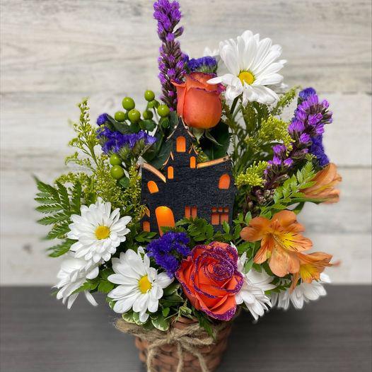 Our colorful Fall flowers surround a light-up Haunted House!  What a fun arrangement to add to someone's Fall décor!  Spook someone today!