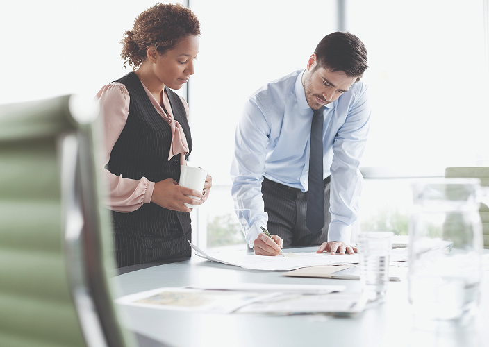 Two professionals looking over some documents.