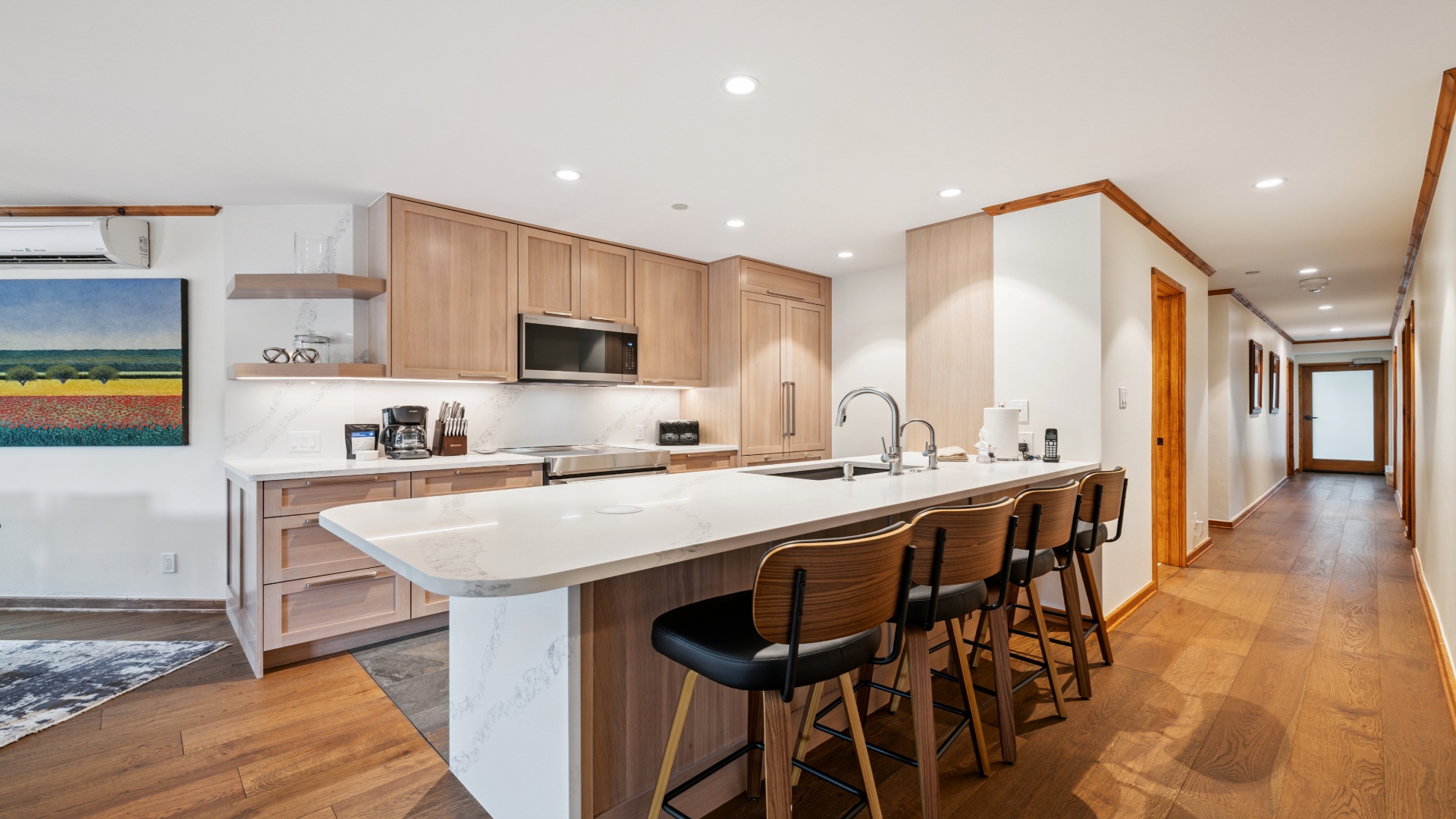 The kitchen with a large island and stools for seating at a condo at Vail Spa Condominiums 
