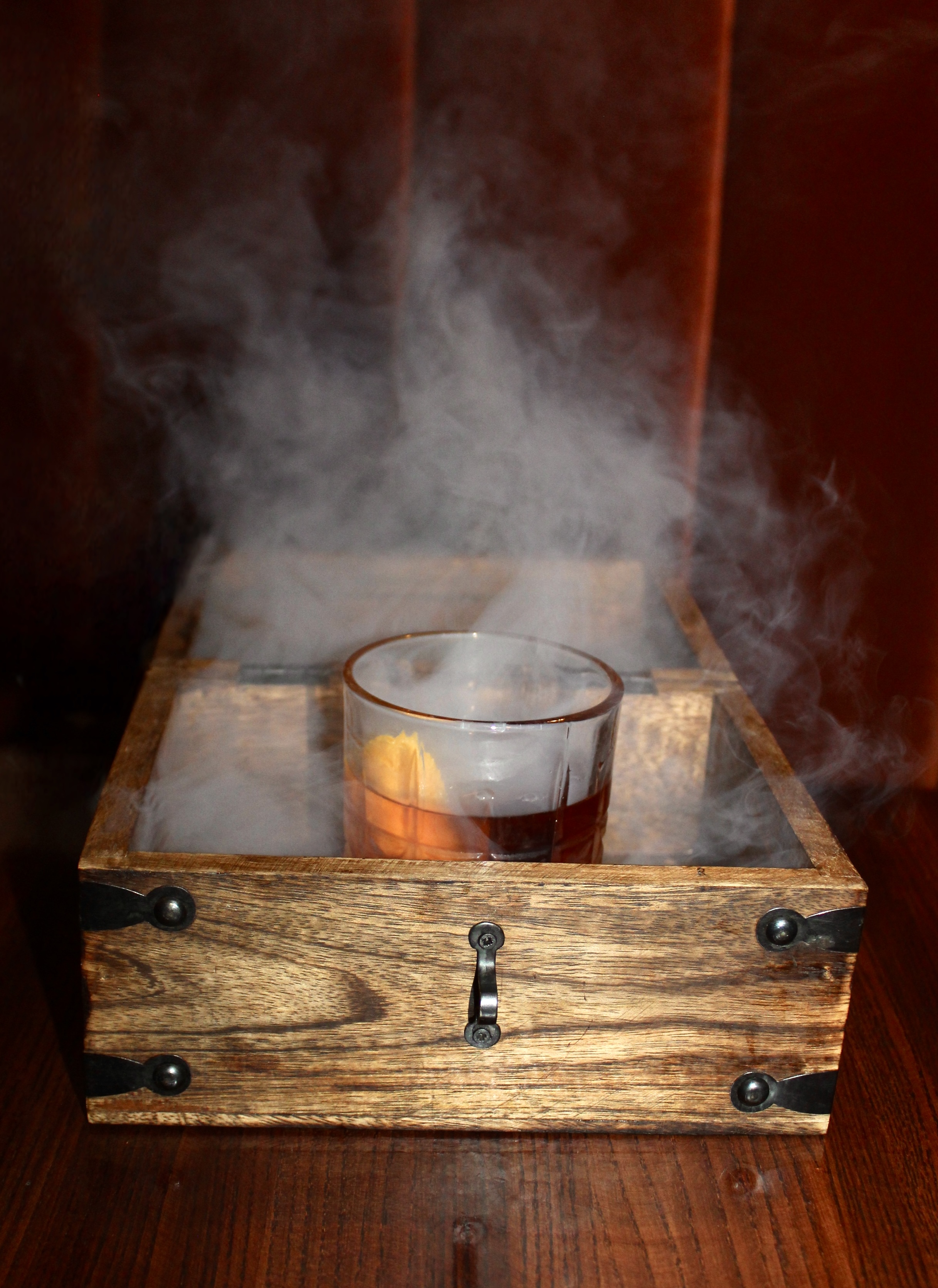 Mama's Signature Treasure Chest Cocktail: Smoked Old Fashioned served in treasure chest 