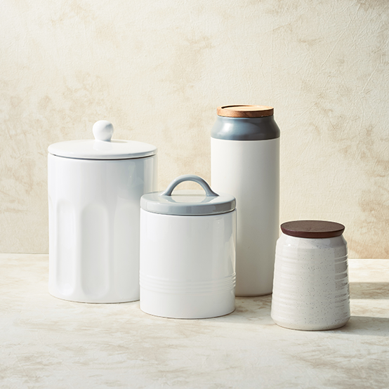 white food canisters with wood tops