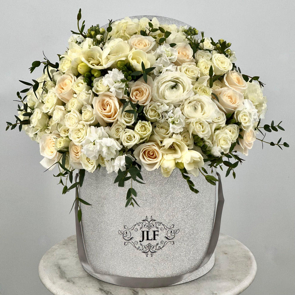 Hello Beautiful
SKU: JLF003972
Combine elegance and luxury with this exquisite all white composition with a touch of greenery. Let these white blooms make your special moments even more magical!