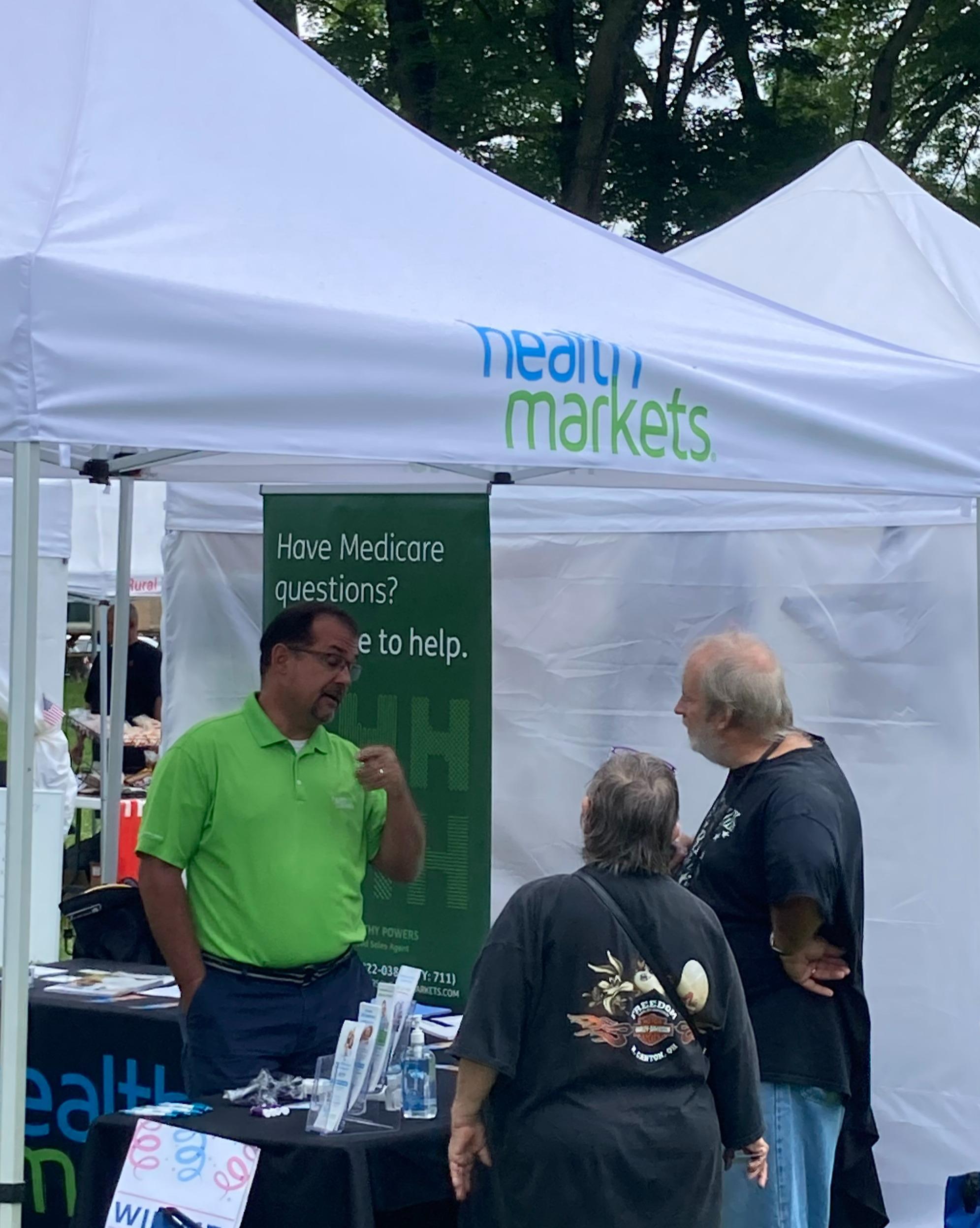 Tim Powers speaking with potential clients at a local community event.